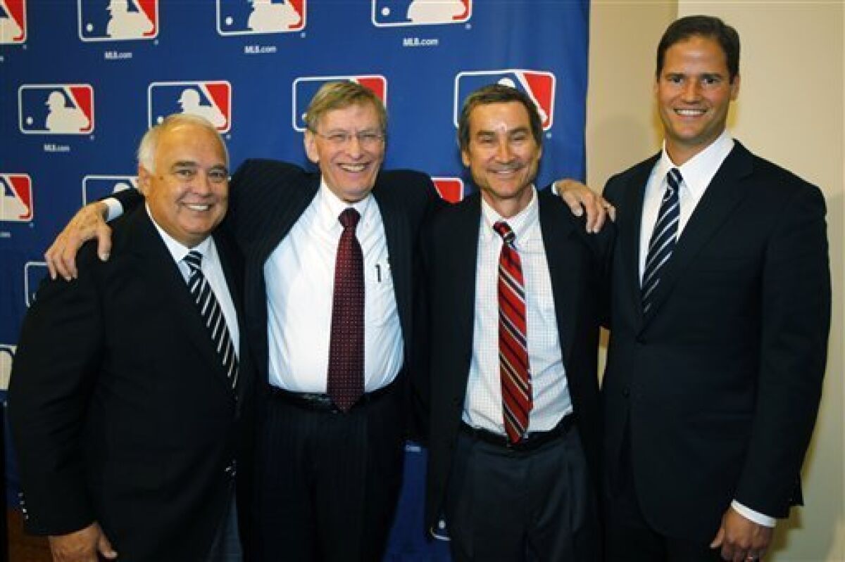 Members of a group approved to buy the San Diego Padres, from left, Ron Fowler, Peter Seidler and Kevin O'Malley.