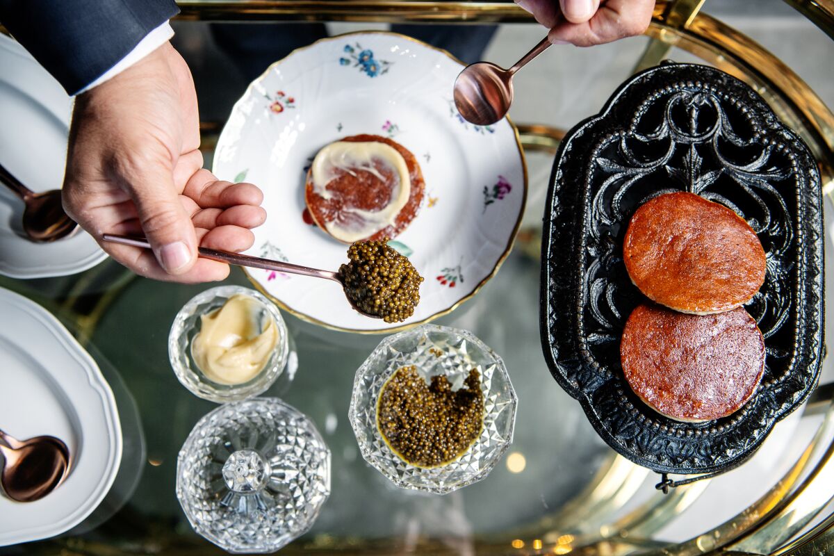 Caviar with banana pancake is assembled tableside at Angler