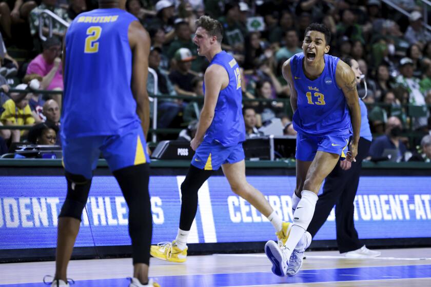 UCLA's Merrick McHenry (13), J.R. Norris IV (2) and Alex Knight (12) celebrate during a win over Hawaii on May 6, 2023.
