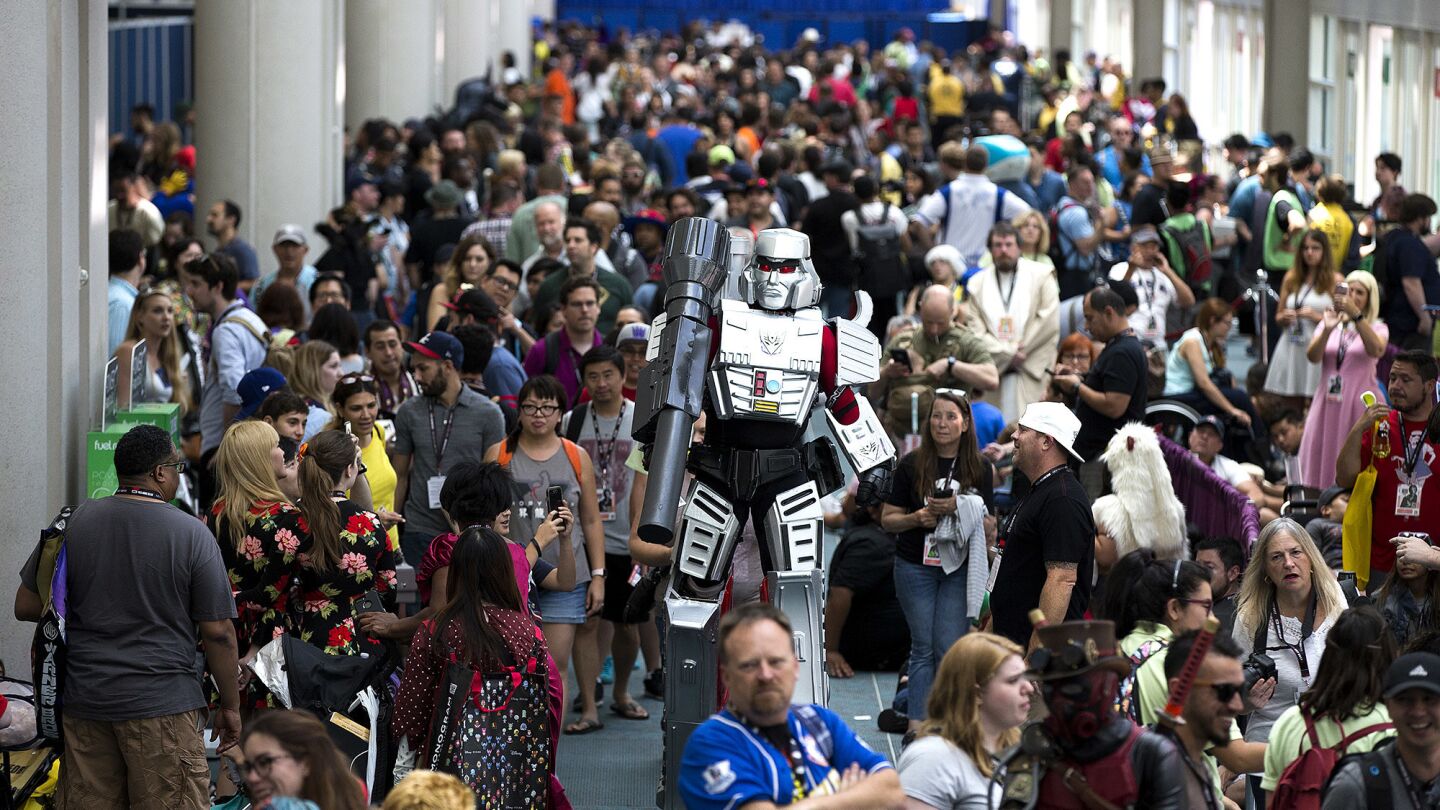 A giant cosplayer walks through large crowds attending Comic-Con 2017 on Saturday at the San Diego Convention Center in San Diego2.