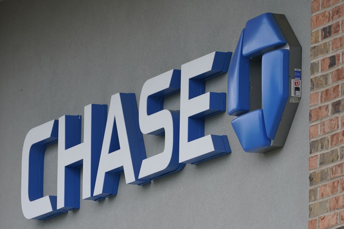 A Chase bank sign in Richmond, Va., Wednesday, June 2, 2021. JPMorgan Chase reported a 24% increase in net income for the third quarter, Wednesday, Oct. 13, 2021. (AP Photo/Steve Helber)