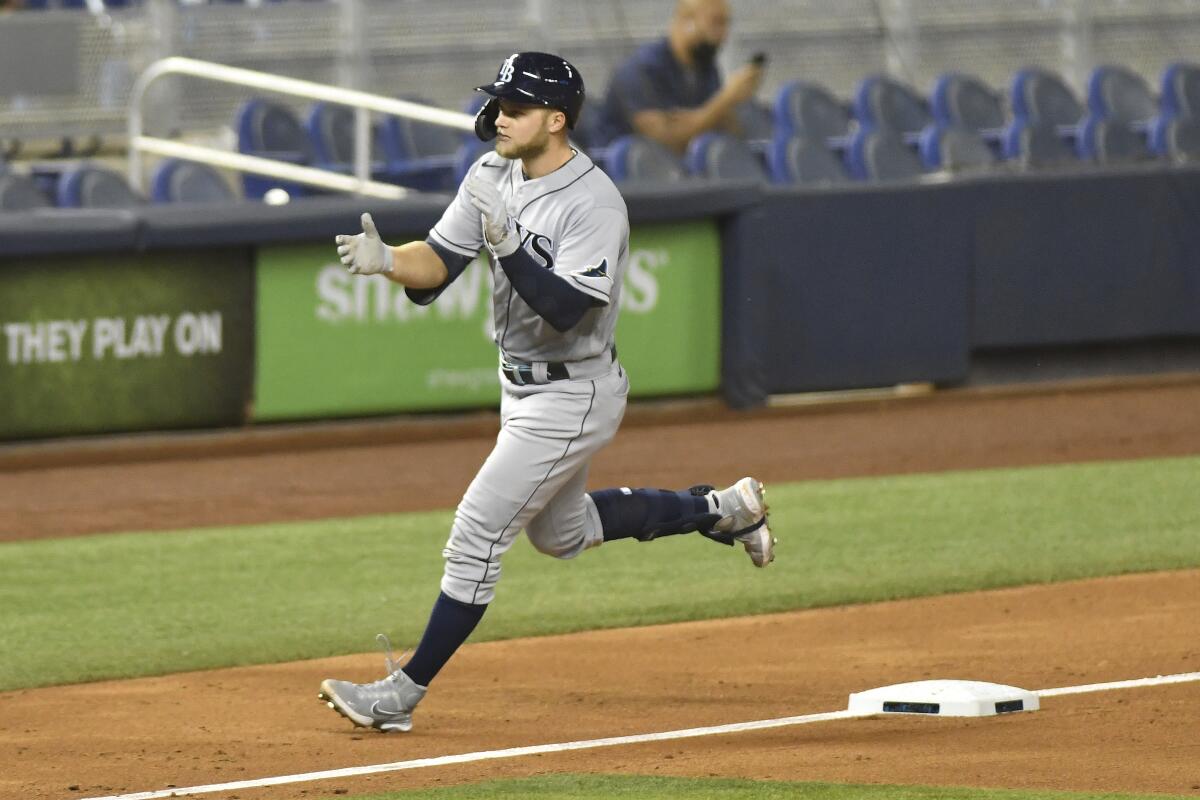 Tampa Bay Rays' Austin Meadows rounds third after hitting home run in the seventh inning of a baseball game against the Miami Marlins, Friday, April 2, 2021, in Miami. (AP Photo/Gaston De Cardenas)