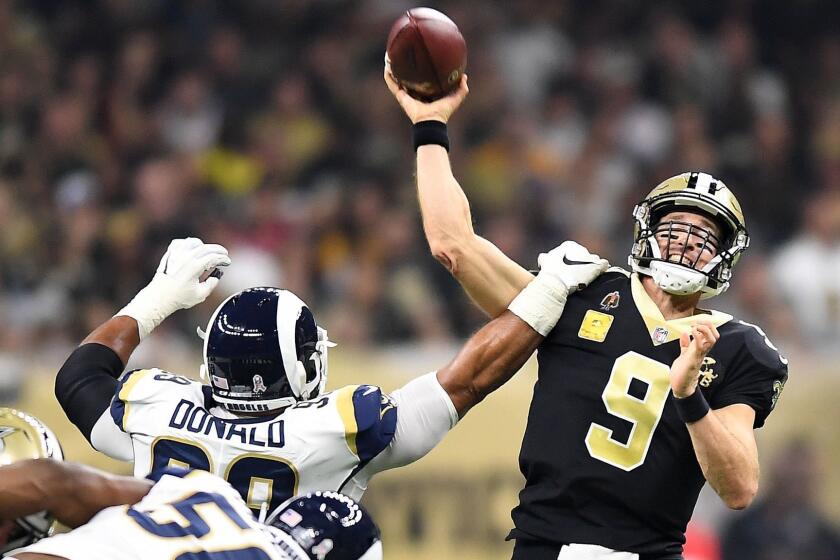 NEW ORLEANS, LOUISIANA, NOVEMBER 4, 2018-Rams Aaron Donald gets an arm on Saints quarterback Drew Brees (9) at the Mercedes Benz Superdome in Louisiana Sunday. (Wally Skalij/Los Angeles Times)