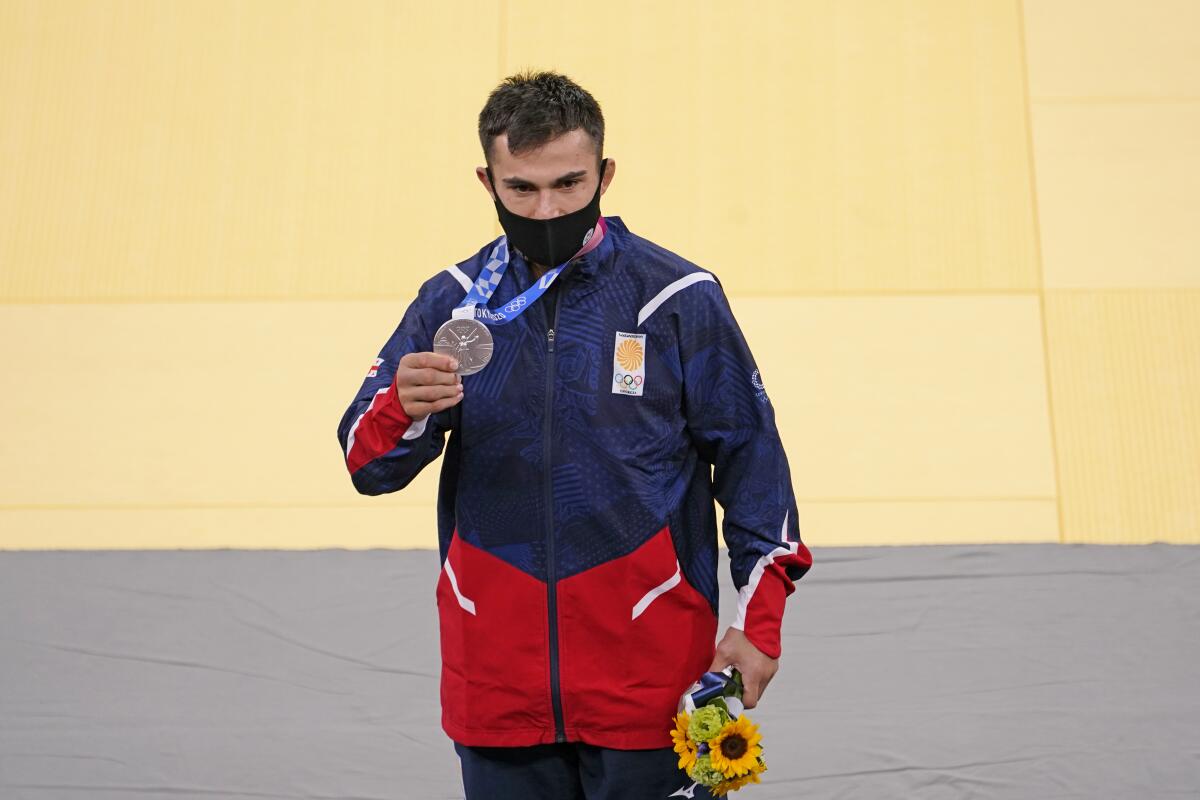 Men's judo silver medalist Vazha Margvelashvili of Georgia stands on the podium.