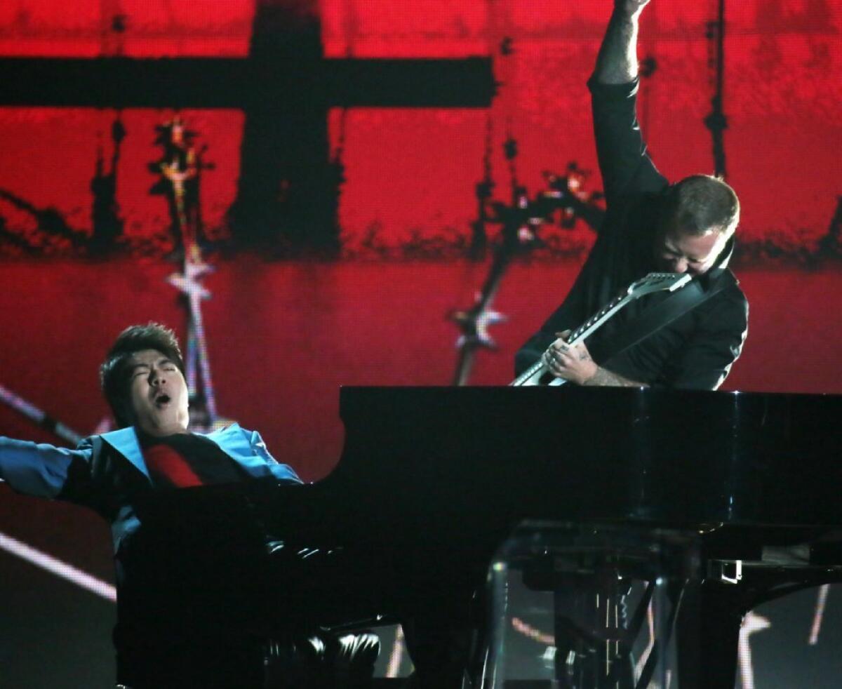 Pianist Lang Lang performs with James Hetfield of Metallica at the Grammy Awards at Staples Center in Los Angeles.