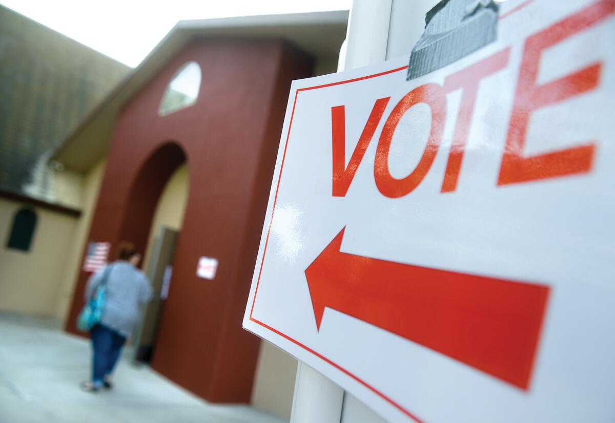 A sign points to a polling station at the First Baptist Church in Porterville on Nov. 4.