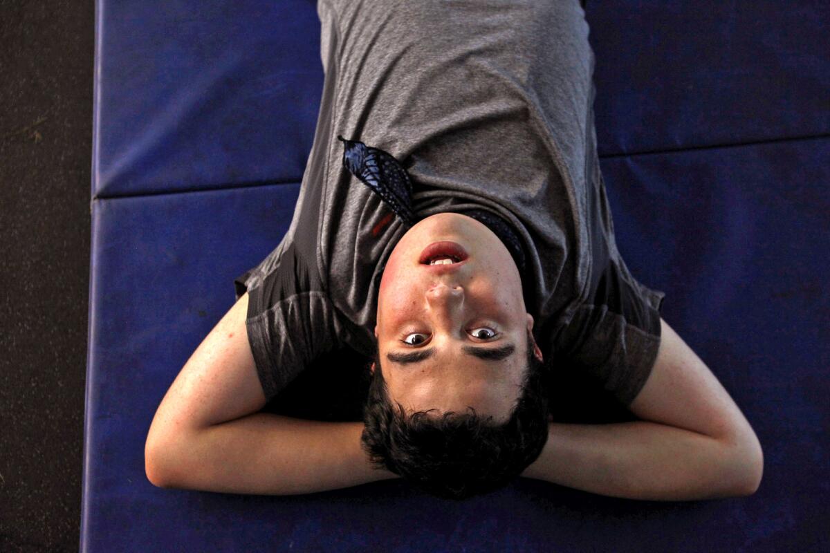 Ido Kedar takes a breather while working out at a local high school. Kedar doesn't play sports but his parents try to keep him in shape by having him work out with a special fitness instructor.