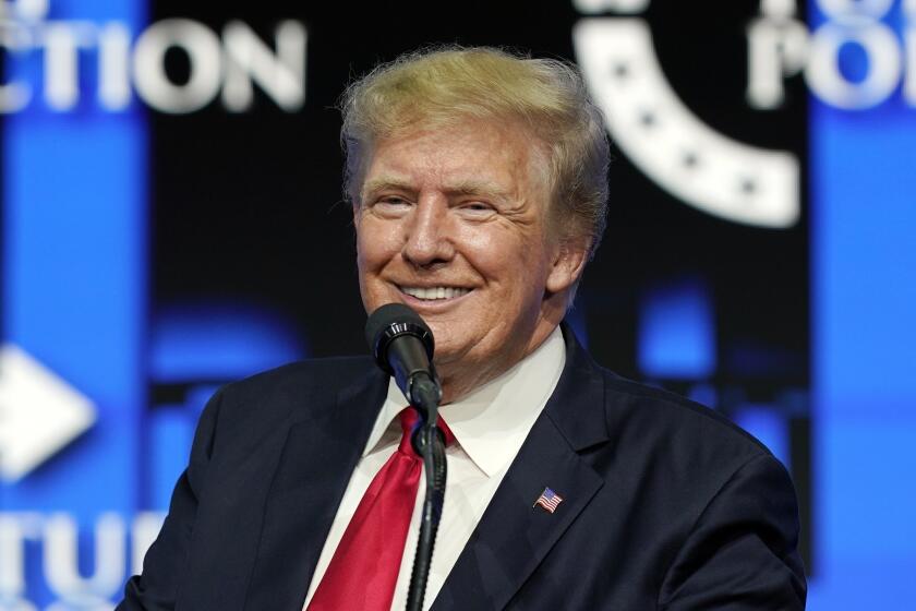 FILE - In this July 24, 2021, file photo former President Donald Trump smiles as he pauses while speaking to supporters at a Turning Point Action gathering in Phoenix. Trump's new social media company forecasts it may have 81 million users by 2026, or nearly 7 million more people than voted for him in the last U.S. presidential election. The projection was filed on Monday, Dec. 6, 2021 with securities regulators by the company trying to bring Trump Media & Technology Group to the stock market. (AP Photo/Ross D. Franklin, File)