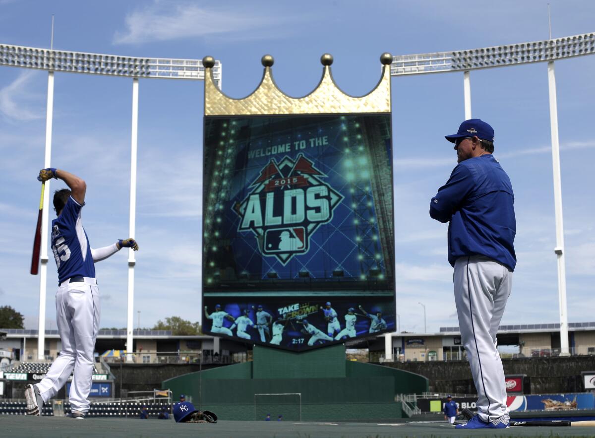 Royals Manager Ned Yost, right, watches as Eric Hosmer, left, warms up for batting practice during a workout at Kaufmann Stadium Wednesday.