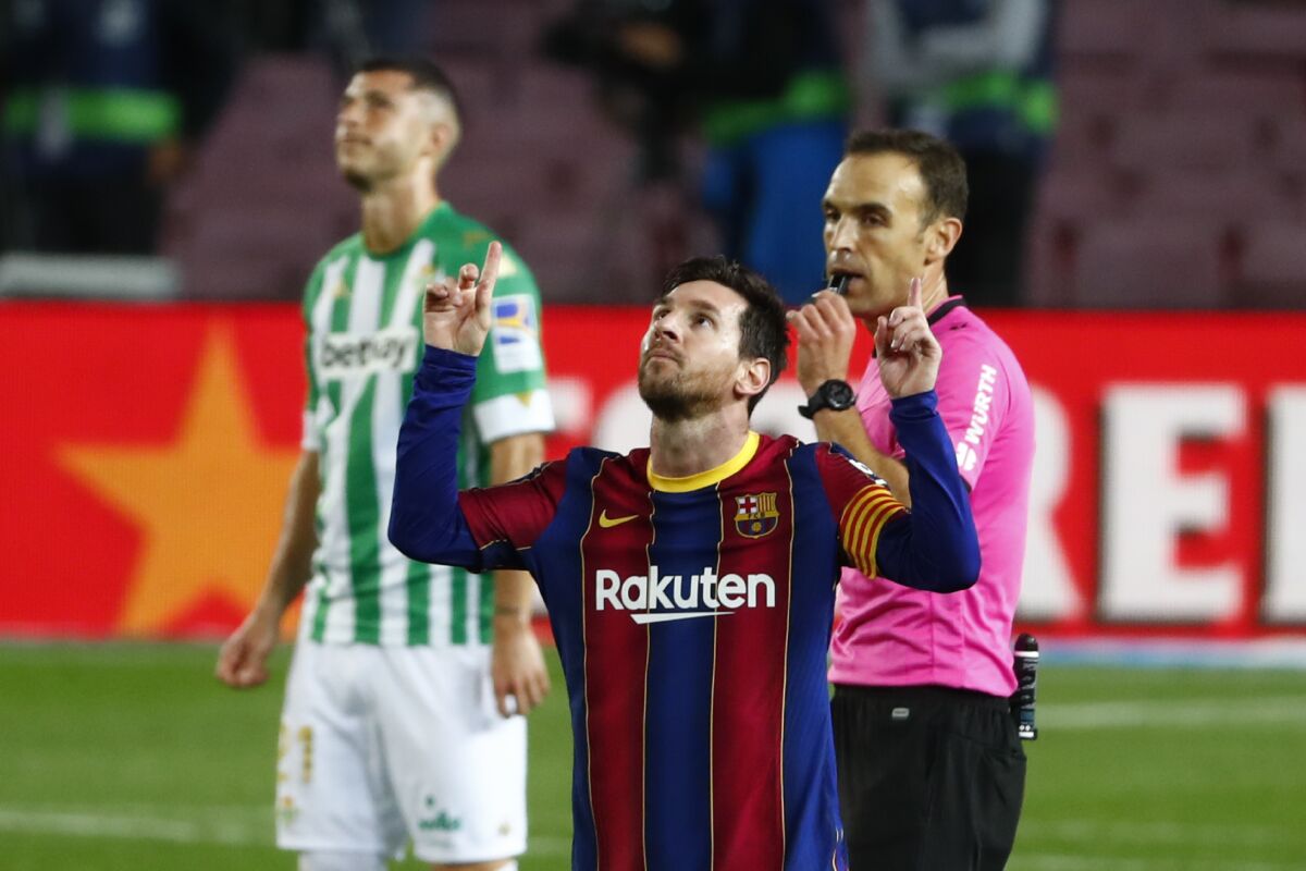 Barcelona's Lionel Messi celebrates after scoring his side's fourth goal during the Spanish La Liga soccer match between FC Barcelona and Betis at the Camp Nou stadium in Barcelona, Spain, Saturday, Nov. 7, 2020. (AP Photo/Joan Monfort)