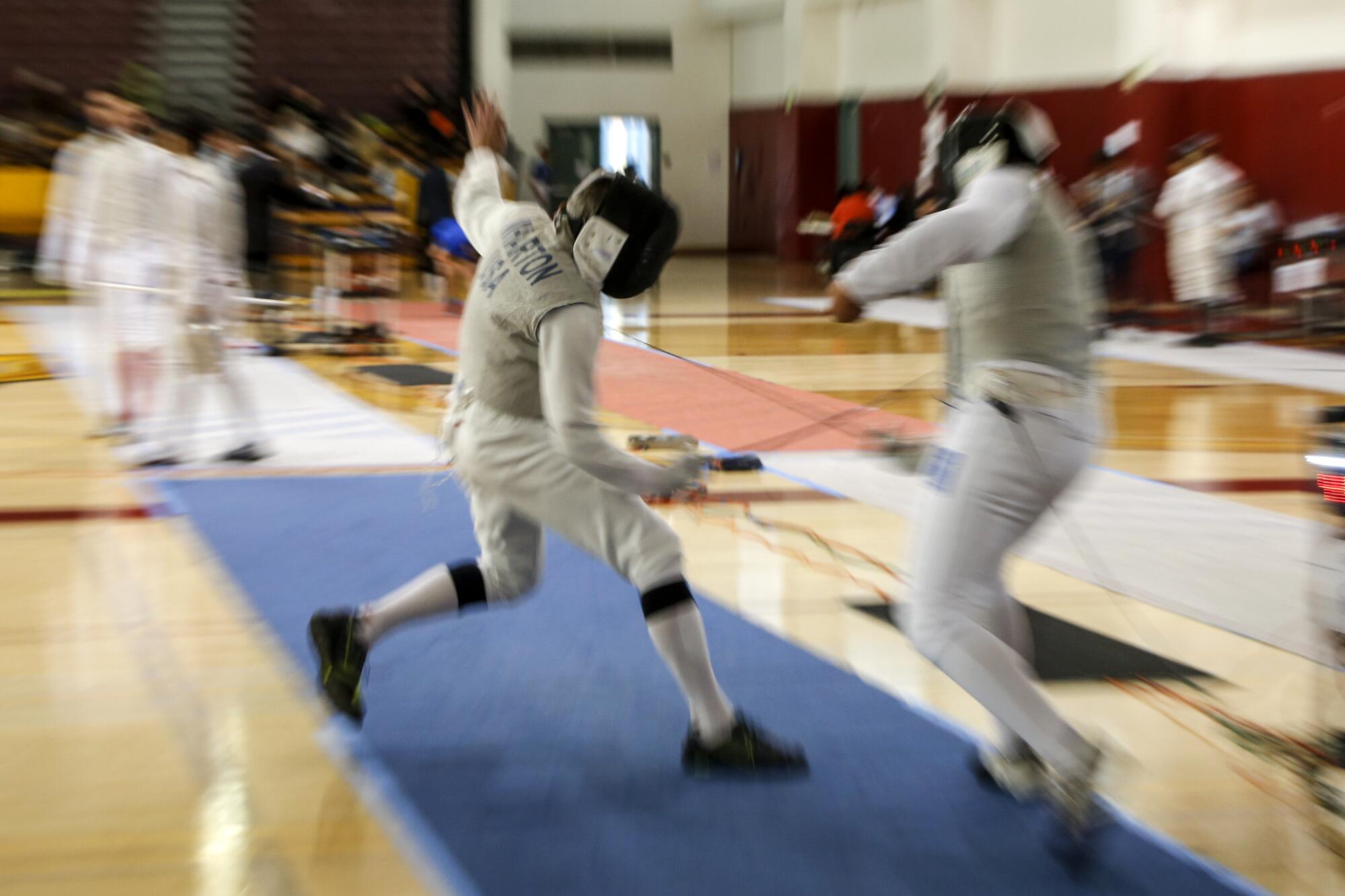 David Wharton competes against another fencer in the senior foil event.