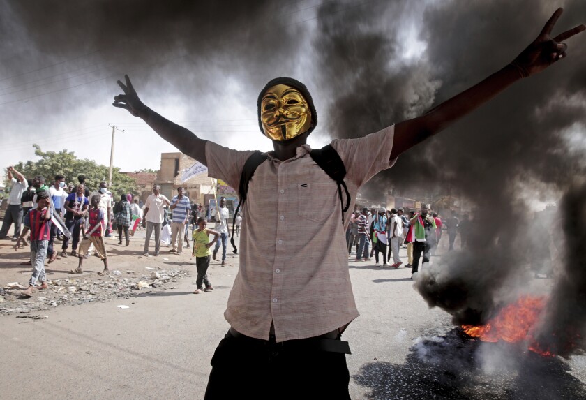 A man flashes the victory sign during a protest to denounce the October 2021 military coup, in Khartoum, Sudan, Sunday, Jan. 9, 2022. The United Nations said Saturday it would hold talks in Sudan to try to get the country's democratic transition back on track after it was derailed by the coup. (AP Photo/Marwan Ali)