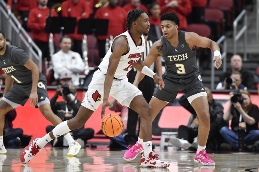 Louisville forward Jae'Lyn Withers (24) drives around Georgia Tech guard Dallan Coleman (3) during the first half of an NCAA college basketball game in Louisville, Ky., Wednesday, Feb. 1, 2023. Louisville won 68-58, and Withers scored 19 points and 13 rebounds. (AP Photo/Timothy D. Easley)