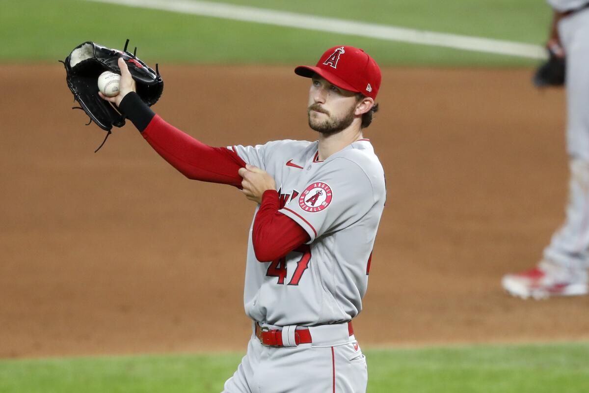 Angels starting pitcher Griffin Canning walks behind the mound after giving up a single.