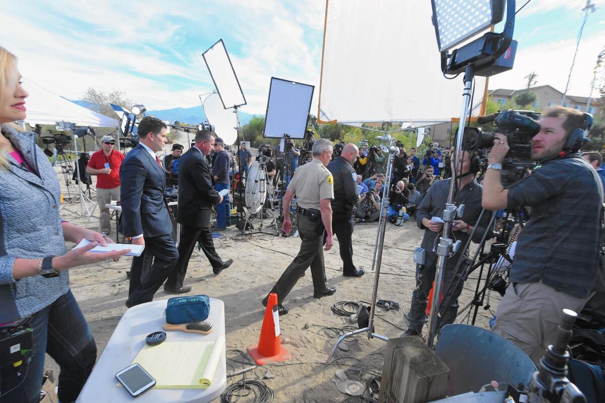Media wait for law enforcement officials to begin a news conference after the mass shooting in San Bernardino on Dec. 3, 2015.