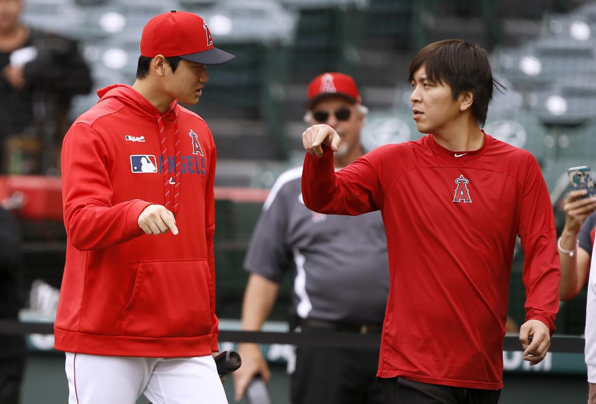 Shohei Ohtani talks with Ippei Mizuhara before an Angels game.