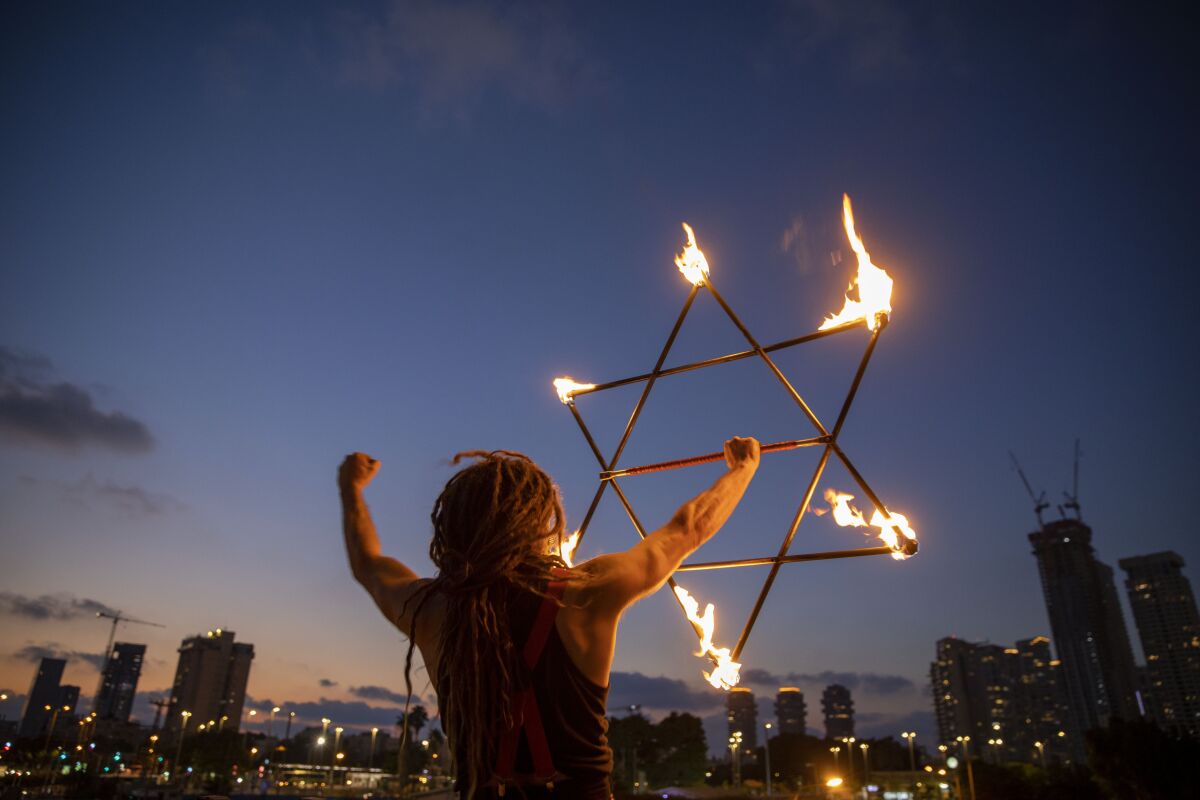 A man holds a Star of David during a protest Saturday in Tel Aviv against Israeli Prime Minister Benjamin Netanyahu.