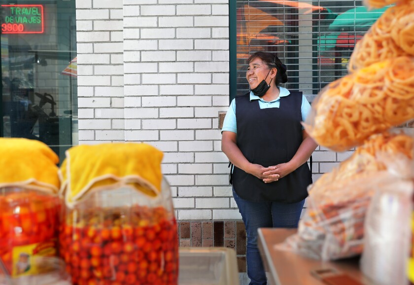 Silvia Trujillo, 50, a street vendor, sells fruit and other food and beverage items, in Santa Ana.