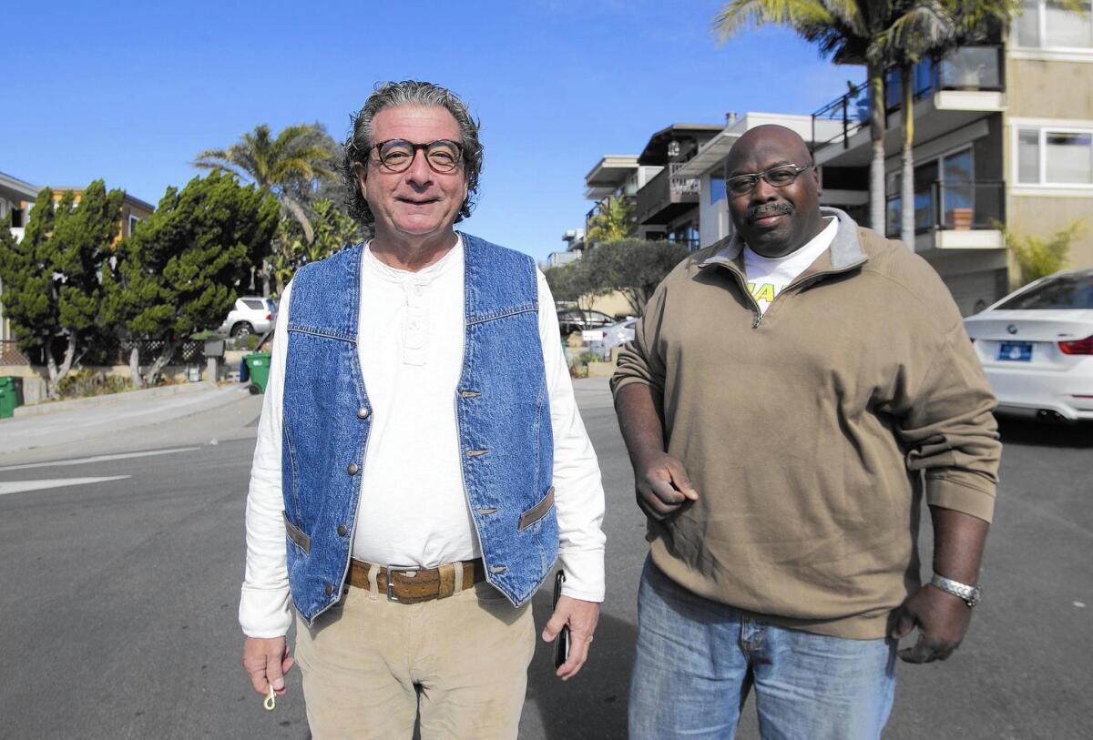 Pastor Don Sciortino, left, walks with Walter Randolph in Laguna Beach.