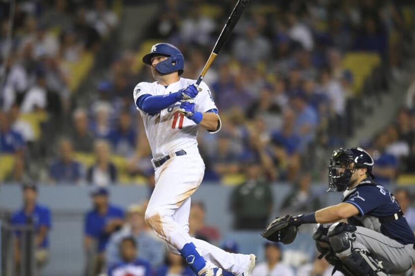 LOS ANGELES, CA - SEPTEMBER 18: A.J. Pollock #11 of the Los Angeles Dodgers flies out while Travis d'Arnaud #37 of the Tampa Bay Rays looks on at Dodger Stadium on September 18, 2019 in Los Angeles, California. The Rays won in the 11th inning 8-7. (Photo by John McCoy/Getty Images)