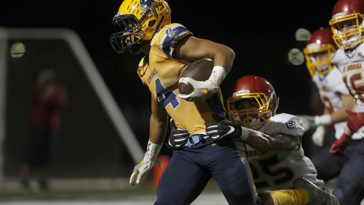 Pharoah Rush, pictured carrying the ball against El Modena on Sept. 21, 2018, and Marina suffer their first setback of the season with Friday's 28-24 loss to the Vanguards.