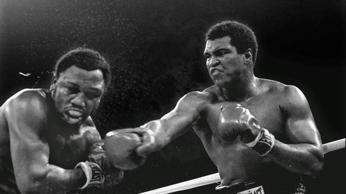 Muhammad Ali connects with a right in a title fight against Joe Frazier in Manila on Oct. 1, 1975.