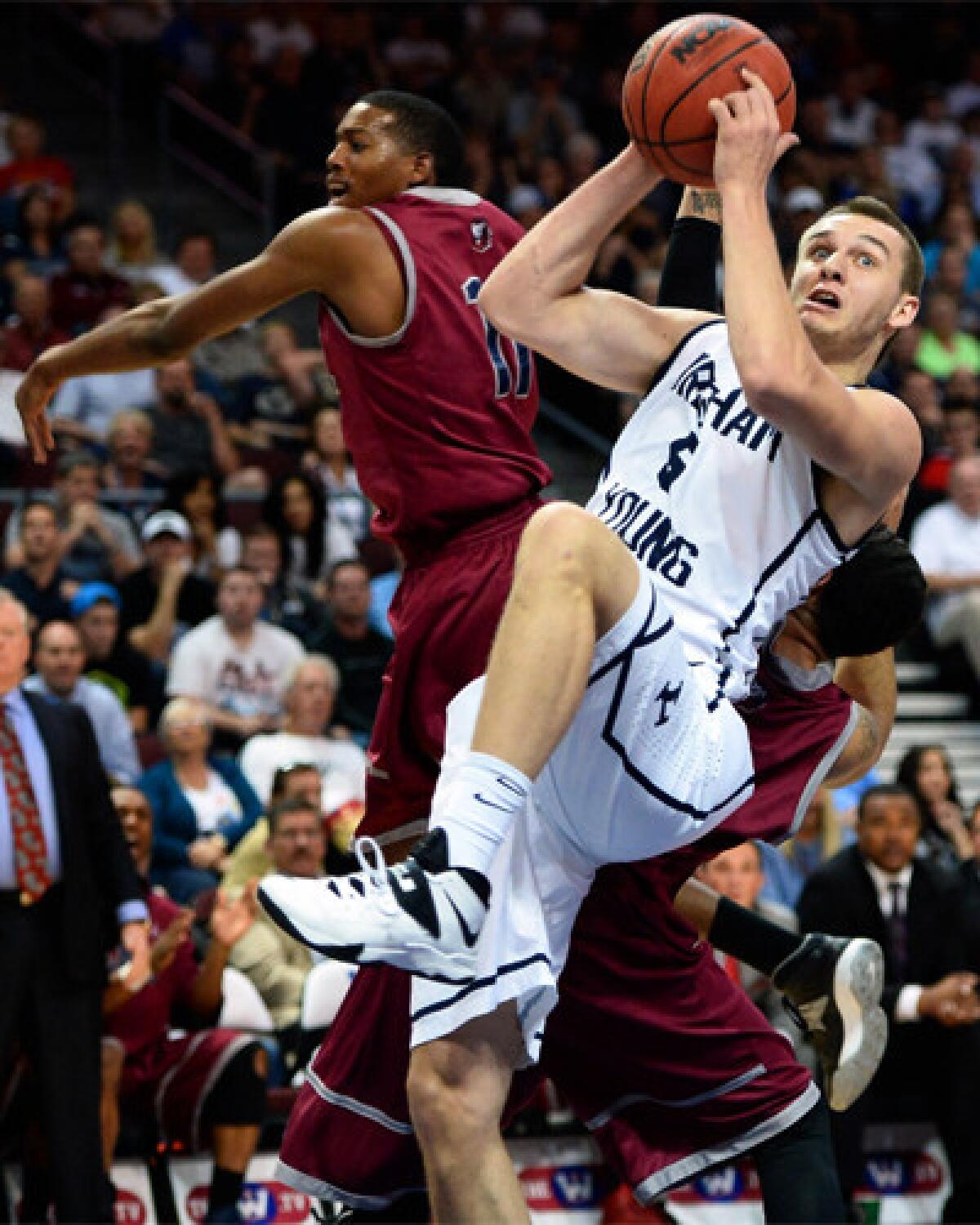 Brigham Young's Kyle Collinsworth is fouled by Loyola Marymount's Nick Stover during a quarterfinal game of the West Coast Conference basketball tournament Saturday in Las Vegas.