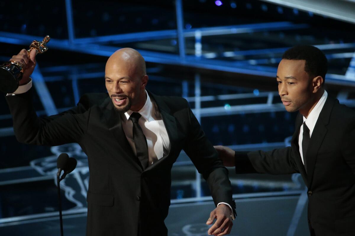 Two men accept an Academy Award