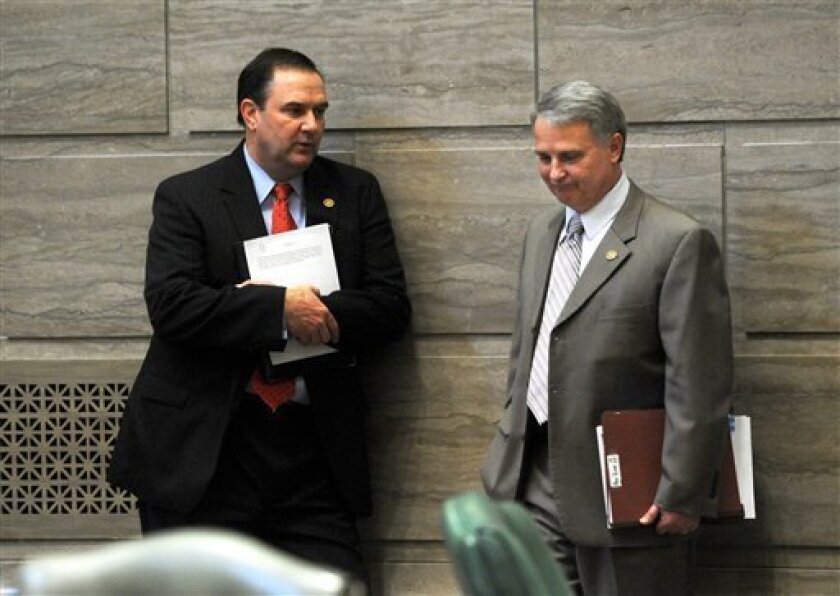 In this March 30, 2011 photo, Sen. Mike Kehoe, R-Jefferson City, left, and Senate President Pro Tem Rob Mayer, R-Dexter, confer briefly at the State Capitol in Jefferson City, Mo. Right-to-work bills have been considered this year in 14 states, including Missouri, but many are faltering. Mayer has said he plans to bring the issue up again in the Senate before the session ends. Keheo, who owns a car dealership, has said he supports efforts to improve the state's business climate but that he doesn't think right-to-work legislation is a magic wand. (AP Photo/Kelley McCall)