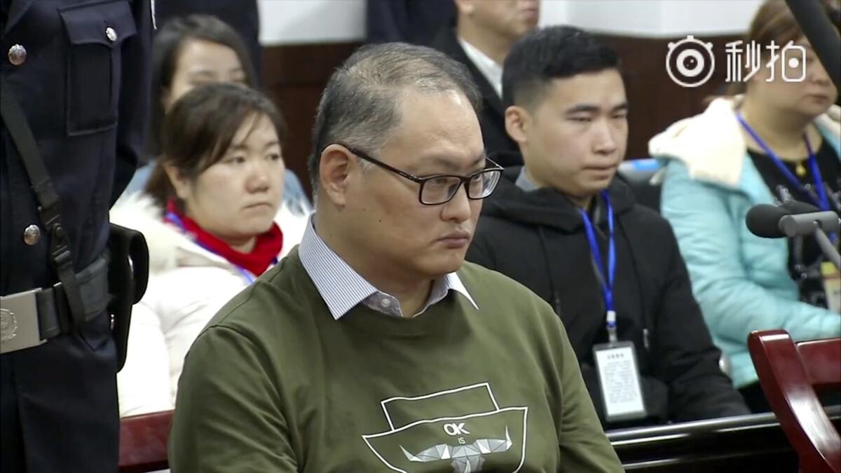 FILE - In this image taken from a video taken and released on Nov. 28, 2017, by the Intermediate People's Court of Yueyang, Taiwanese human rights activist Lee Ming-che sits during a court session at the Intermediate People's Court of Yueyang in Yueyang in central China's Hunan Province. The Taiwanese pro-democracy activist who served five years in China returned to Taiwan on Friday morning, April 15, 2022, the island's Central News Agency reported. (Intermediate People's Court of Yueyang via AP Video, File)