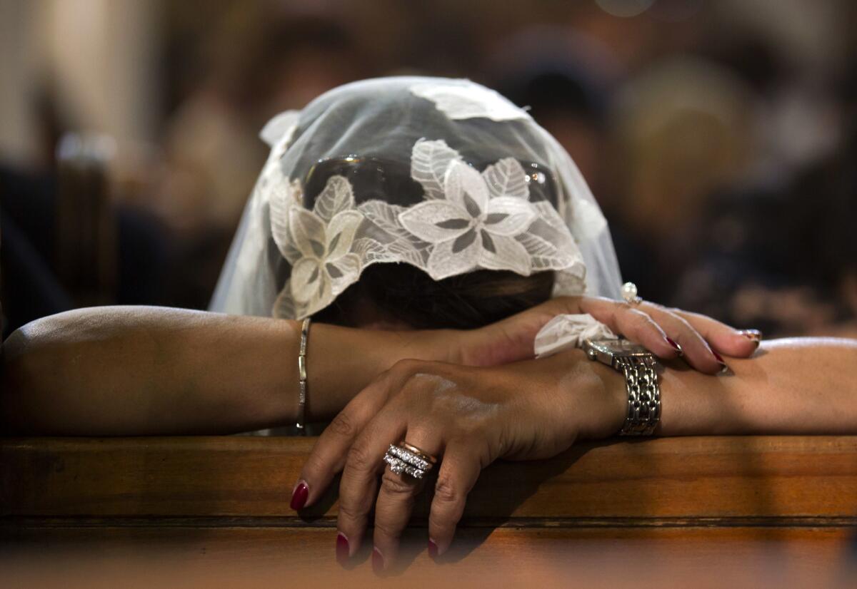 A Coptic Christian grieves during prayers for the victims of Thursday's crash of EgyptAir Flight 804, at Al-Boutrossiya Church in Cairo on May 22, 2016.