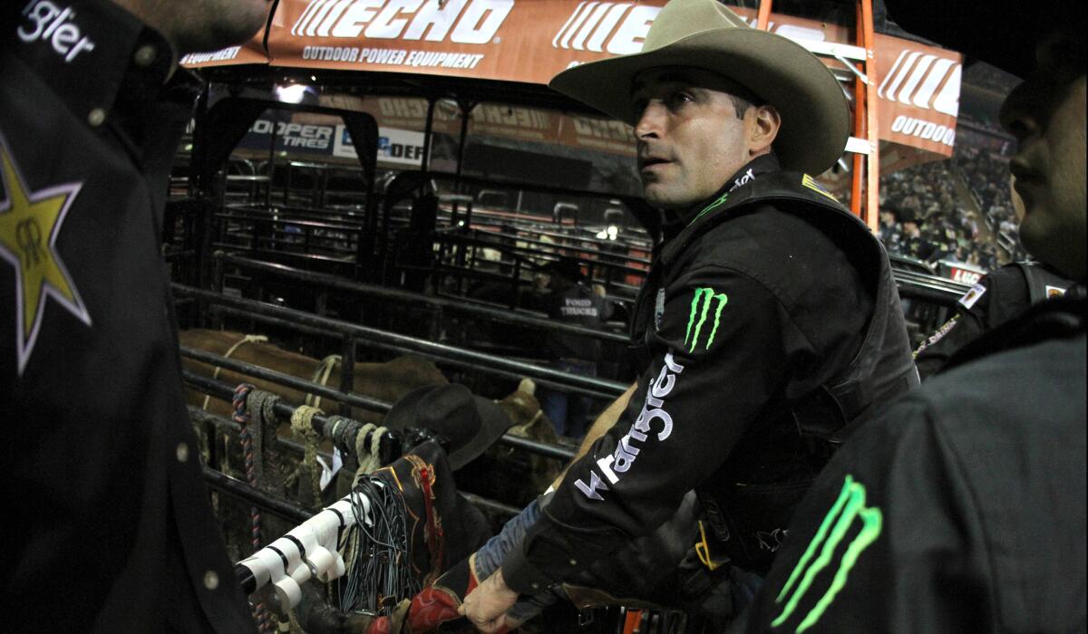 Guilherme Marchi adjusts his boots in between rounds during the Professional Bull Riders Buck Off last month at Madison Square Garden.