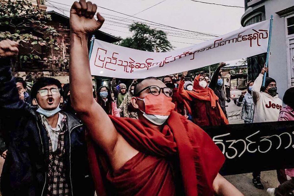 A Buddhist monk raises his clenched fist while marching during an anti-military government protest rally on Tuesday, Feb. 1, 2022, in Mandalay, Myanmar. The new U.N. special envoy for Myanmar says violence has intensified since the military took power a year ago and sparked a resistance movement in the country. (AP Photo)