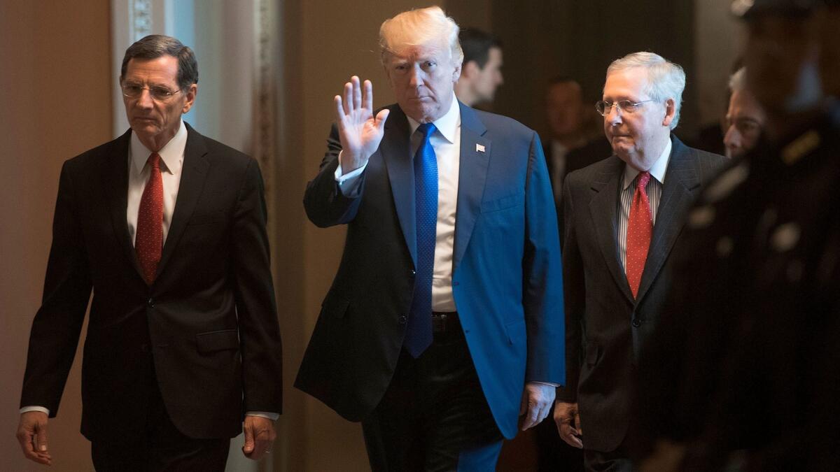 President Trump at Capitol Hill flanked by Sen. John Barrasso (R-Wyo.), left, and Senate Majority Leader Mitch McConnell (R-Ky.).