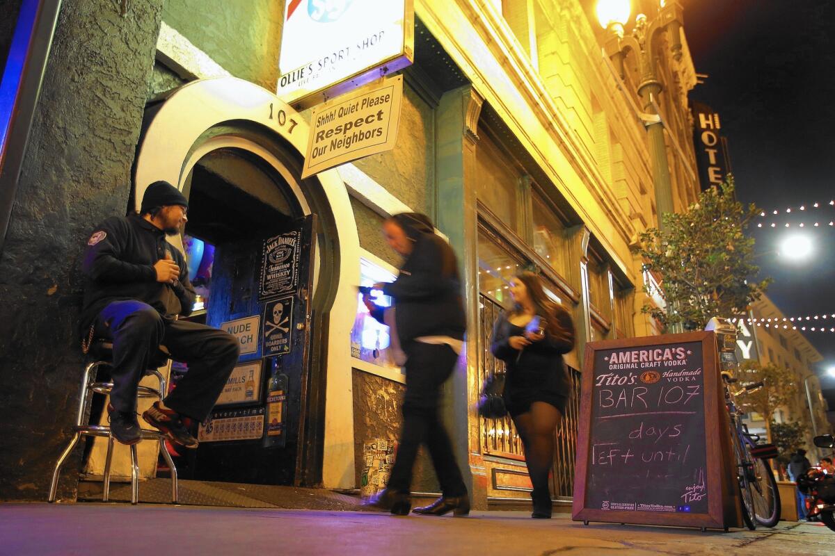 A security guard checks IDs of patrons entering Bar 107 in downtown Los Angeles, which is facing the loss of its lease. The bar's owner has vowed not to leave without a fight, and has hit a sweet spot on social media.