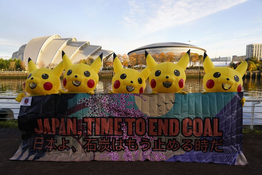 Activists dressed as the Pokemon character Pikachu protest against Japan's support of the coal industry near the COP26 U.N. Climate Summit in Glasgow, Scotland, Thursday, Nov. 4, 2021. The U.N. climate summit in Glasgow gathers leaders from around the world, in Scotland's biggest city, to lay out their vision for addressing the common challenge of global warming. (AP Photo/Alberto Pezzali)