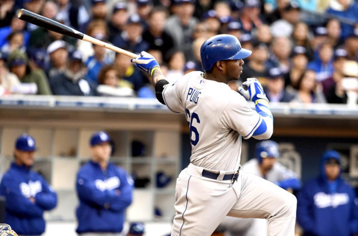 Dodgers right fielder Yasiel Puig follows through on a single against the Padres on Tuesday night in San Diego.