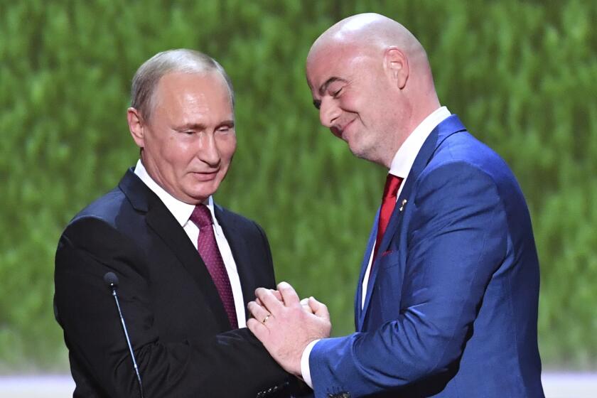 FILE - FIFA President Gianni Infantino, right, and Russian President Vladimir Putin greet each other.