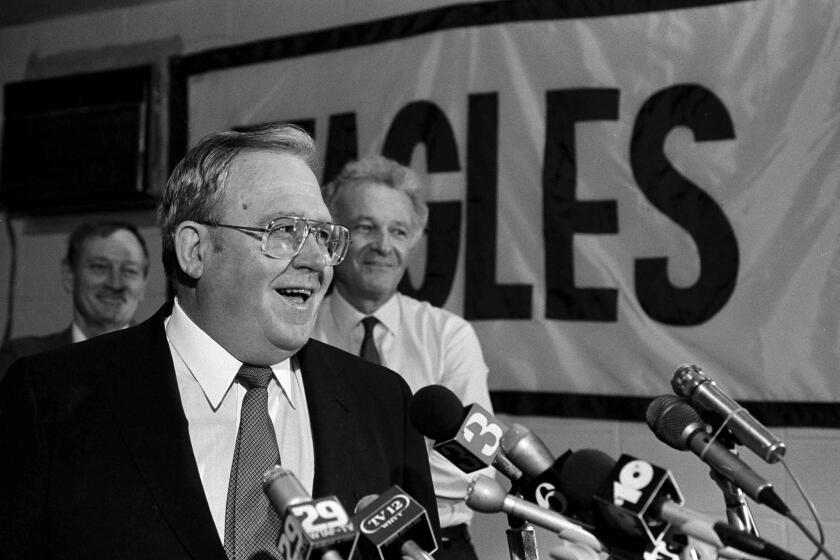 Eagles Coach Buddy Ryan talks with the media after making Ohio State's Keith Byars their number one draft pick on Apr. 29, 1986. Eagles owner Norman Braman stands in the background.