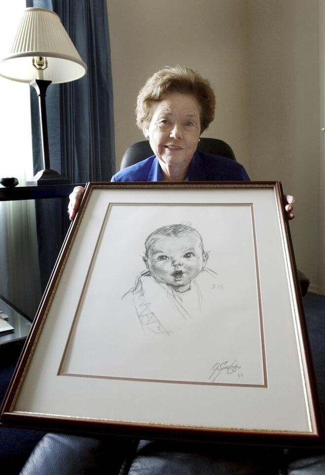 Ann Taylor Cook poses on Feb. 4, 2004 at her Tampa, Fla. home with a copy of her photo that is used on all Gerber baby food products. Gerber says Cook turned 90 on Sunday, Nov. 20, 2016. Birthday: Nov. 20, 1926