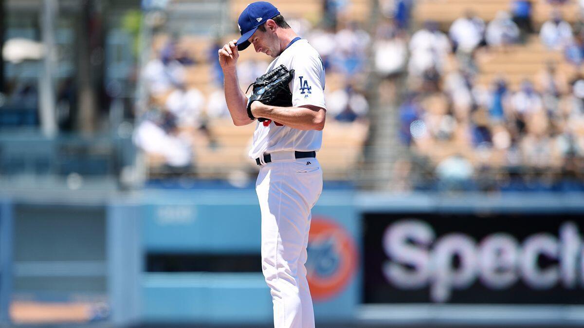 Dodgers pitcher Brandon McCarthy reacts after a wild pitch against the Colorado Rockies during the second inning Sunday at Dodger Stadium.