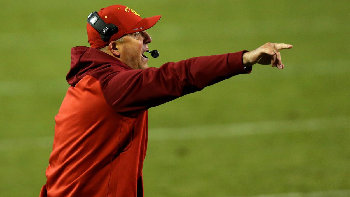 USC interim Coach Clay Helton gives instructions to the Trojans in the third quarter Friday night against Colorado.