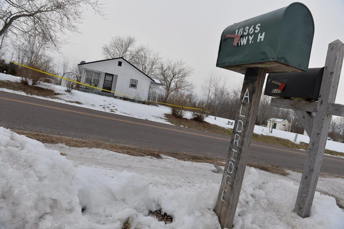 Police perimeter tape cordons off one of the crime scenes in Tyrone, Mo., where seven people were shot to death this week. The gunman then killed himself.