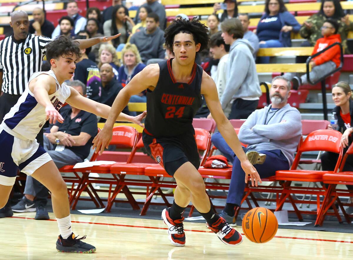Jared McCain of Corona Centennial drives the baseline against an opponent.
