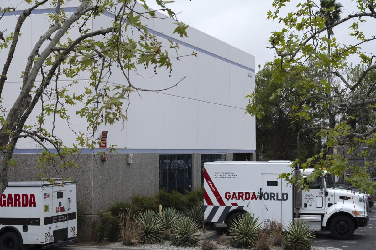Armored trucks are parked outside the GardaWorld facility in the Sylmar section of Los Angeles on Thursday, April 4, 2024. Thieves stole as much $30 million in an Easter Sunday burglary at a Los Angeles money storage facility in one of the largest cash heists in city history. (AP Photo/Richard Vogel)