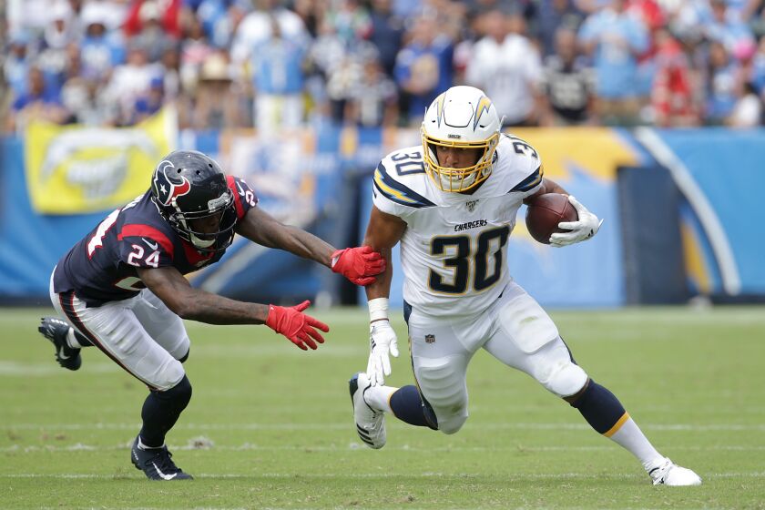 CARSON, CALIFORNIA - SEPTEMBER 22: Austin Ekeler #30 of the Los Angeles Chargers is pursued by Johnathan Joseph #24 of the Houston Texans in the second quarter at Dignity Health Sports Park on September 22, 2019 in Carson, California. (Photo by Jeff Gross/Getty Images)