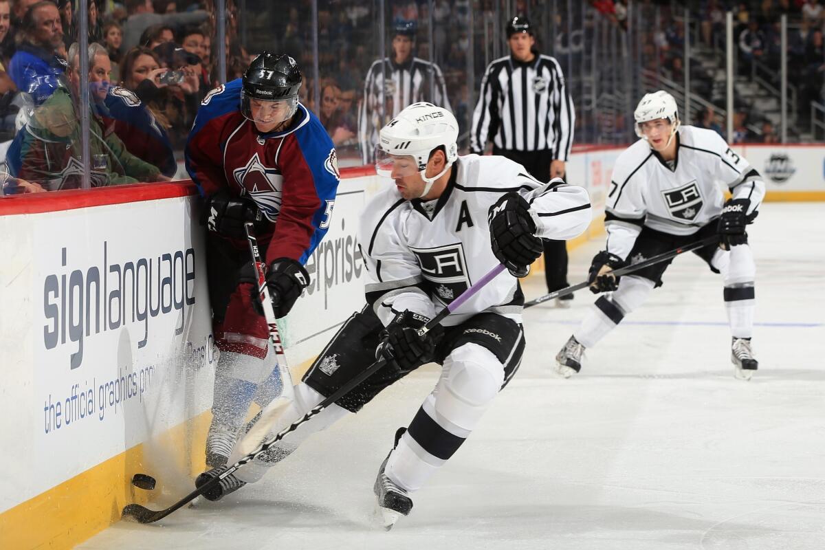 Kings forward Justin Williams, right, battles Colorado defenseman Chris Bigras for the puck during the Kings' 4-3 overtime loss in preseason play Friday.