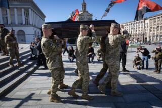 KYIV, UKRAINE - 2024/04/09: Comrades of late Ukrainian servicemen Serhii Konoval and Taras Petryshyn carry their coffins during a farewell ceremony at Independence Square in Kyiv. Serhii Konoval, call sign 'Nord' and Taras Petryshyn, call sign 'Chimera', formerly activists in the 2014 anti-government protests in Ukraine, were serving in the 67th Separate Mechanized Brigade of the Ukrainian Ground Forces when they were killed in action in Chasiv Yar, Donetsk region. (Photo by Oleksii Chumachenko/SOPA Images/LightRocket via Getty Images)