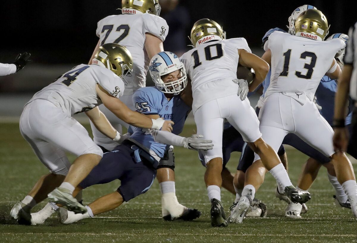 Defensive tackle Ryan Nielsen (45) sneaks through the offensive line to tackle quarterback Michael Tollefson for a loss.