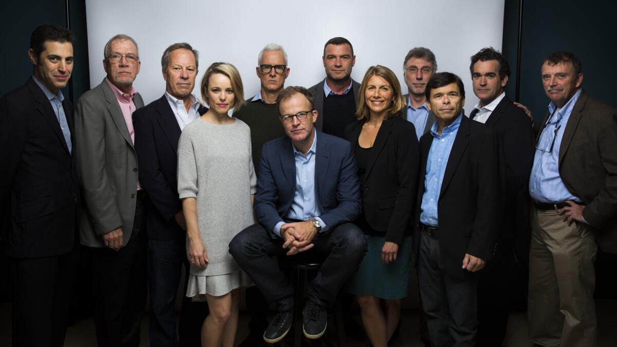 The cast of the film "Spotlight," including Boston Globe journalists and their acting counterparts, are photographed in the L.A. Times photo studio at the Toronto International Film Festival.